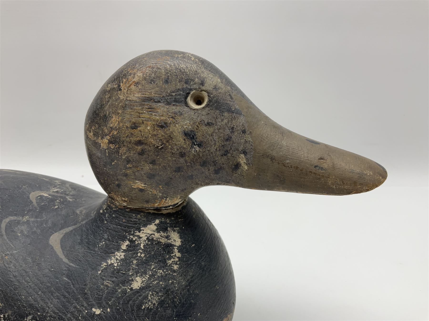 Early 20th century American carved wooden decoy duck, with weight beneath marked CJ Raymond Lead Co Chicago, Ill, H18cm, L38cm 