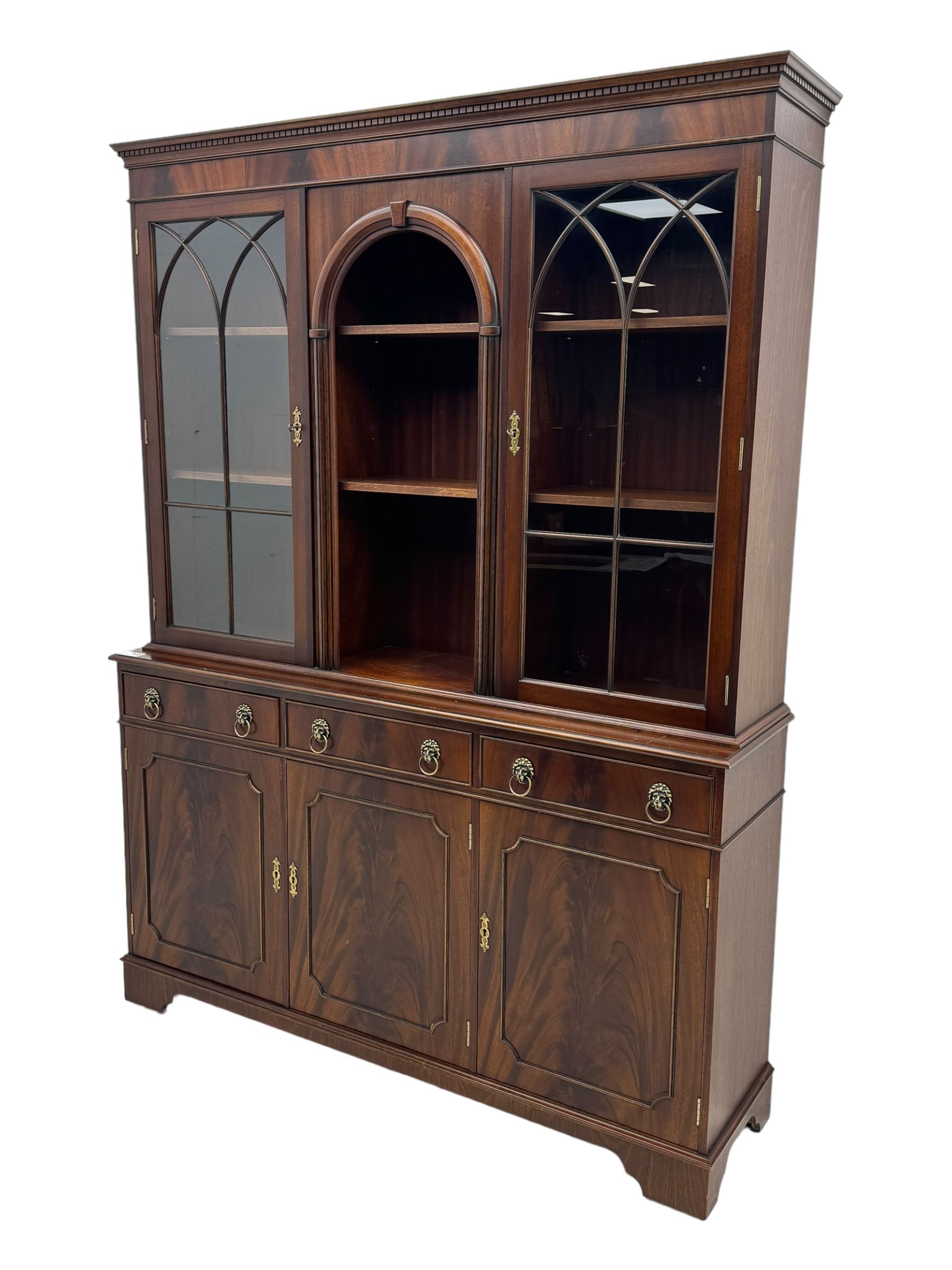 Georgian design mahogany bookcase on cupboard, projecting moulded and dentil cornice, two display cabinets enclosed by glazed doors above over three drawers and three cupboards, on bracket feet