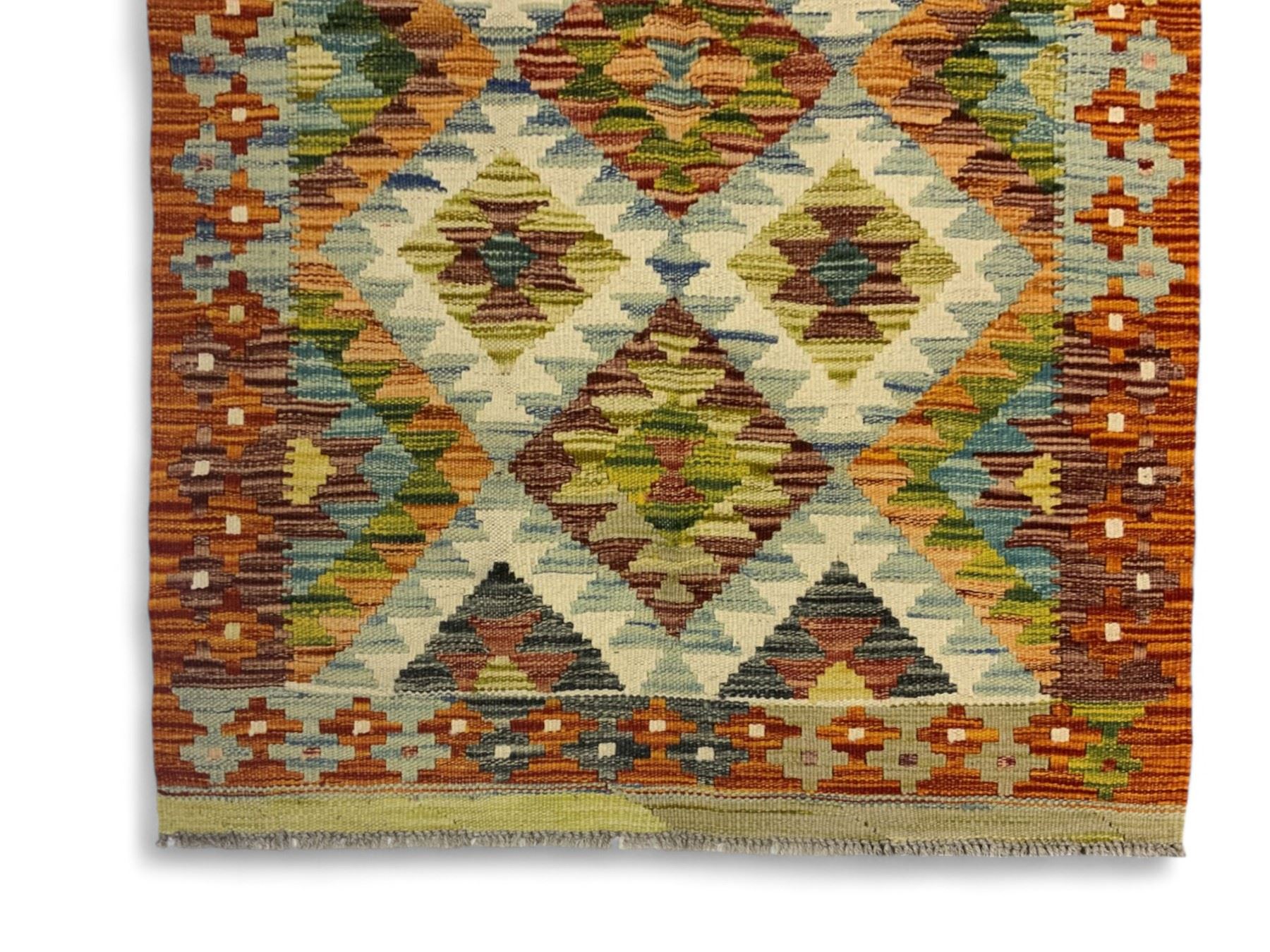 Chobi kilim multi-coloured rug, the field decorated with various lozenges of contrasting colours with ivory outlines, enclosed by a guard band with repeating geometric patterns