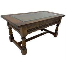 Old Charm - oak coffee table, rectangular top with glass inset over carved scalloped apron, on turned square supports connected by H-stretcher