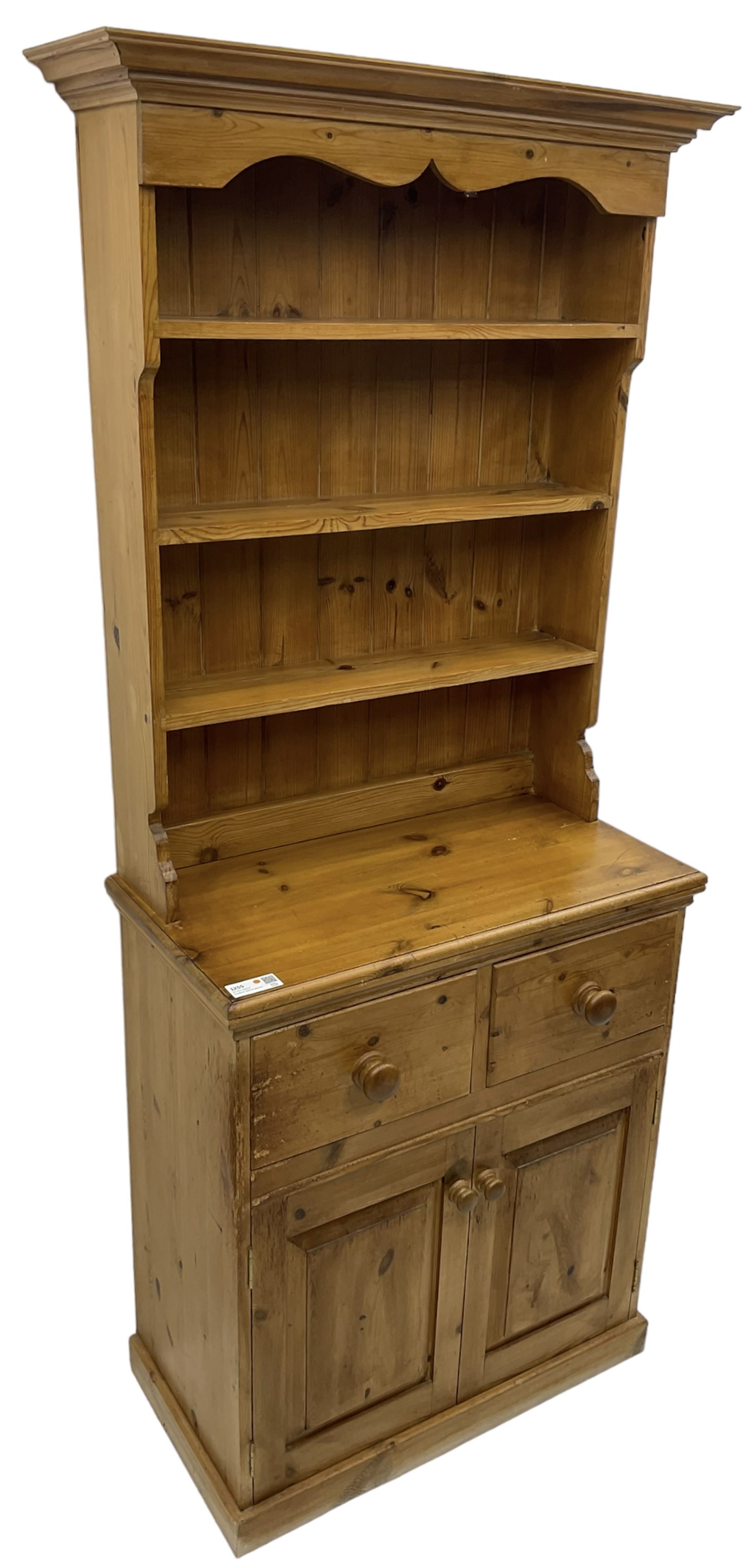 Solid pine dresser, fitted with plate rack above two drawers and two cupboards