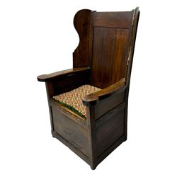 George III oak lambing chair, tall rectangular panelled backrest with shaped wings over broad scrolled armrests, box seat with removable geometric upholstered cushion, integrated drawer to lower section, resting on square supports