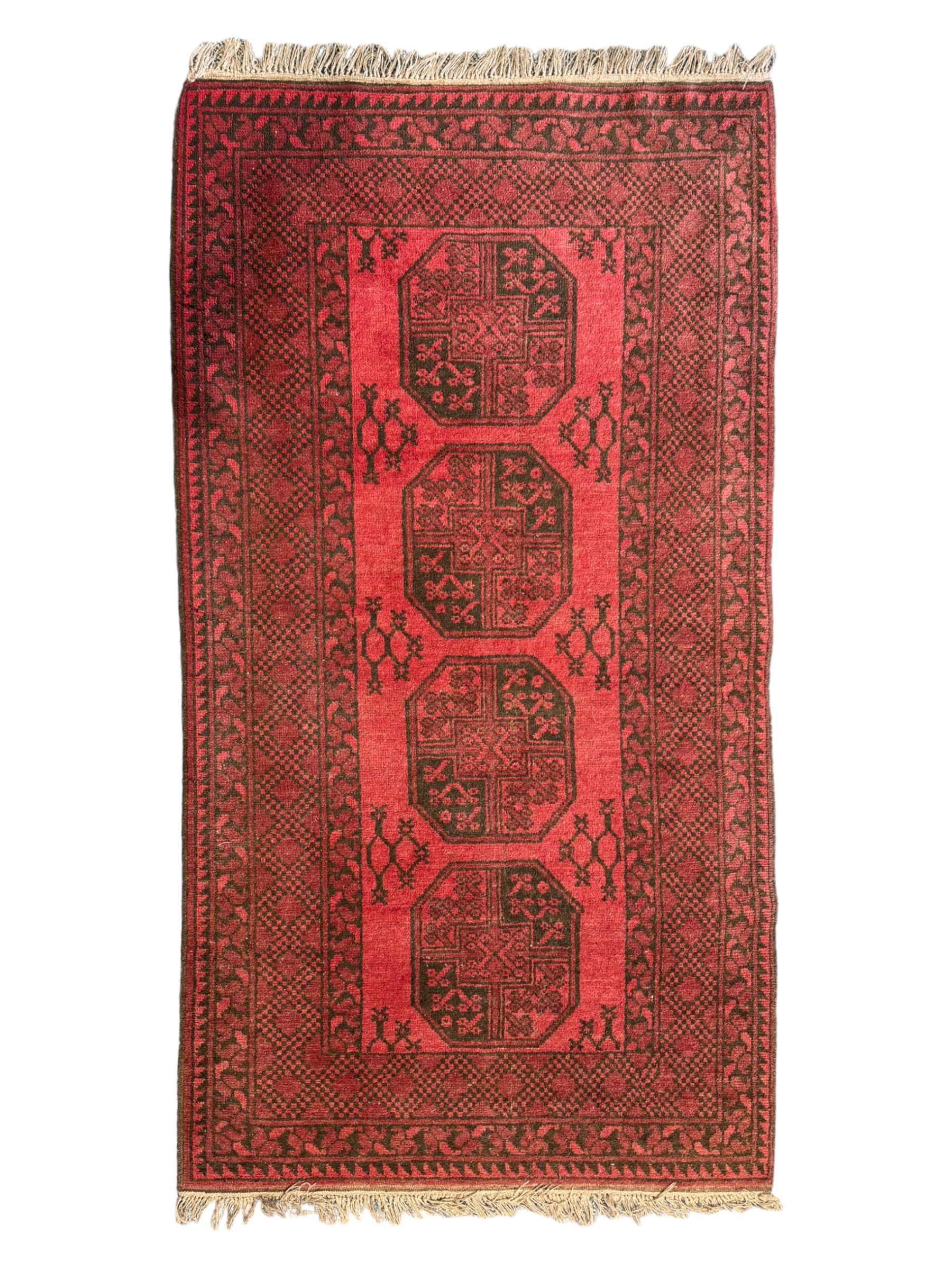 Afghan red ground Bokhara rug, decorated with four central Gul motifs, enclosed by wide geometric guard bands (191cm x 104cm); together with another similar (120cm x 79cm)