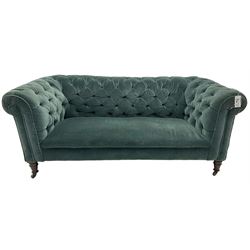 Victorian hardwood-framed Chesterfield sofa, traditional shape with low back and rolled arms, upholstered in teal buttoned fabric, on turned front feet with brass and ceramic castors 