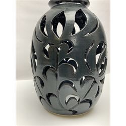 John Egerton (c1945-): studio pottery stoneware lamp base, decorated with pierced floral decoration with a dark blue ground, H56cm 