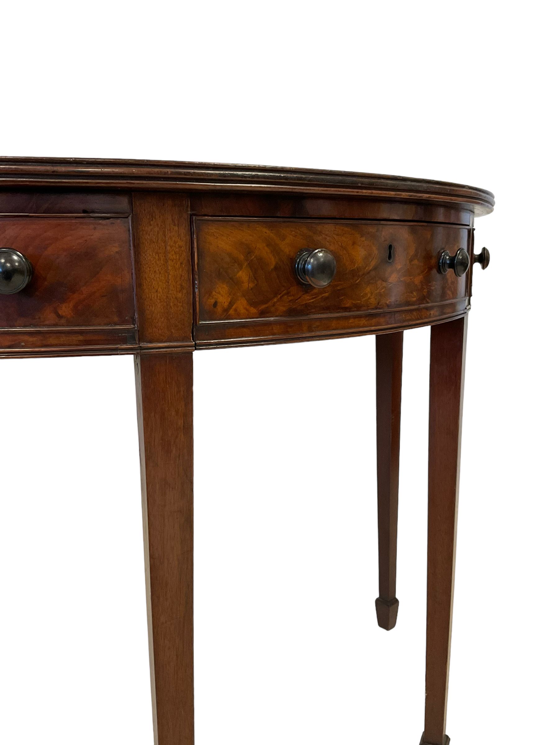 George III mahogany demi-lune side or console table, reeded edge over central frieze drawer flanked by two hinged drawers with cock-beaded facias and turned handles, raised on square tapering supports with spade feet, the rear supports and feet chamfered in profile