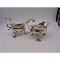 Near pair of George II silver sauce boats, each of oval form with shaped rim and capped flying scroll handle, upon three scroll mounted feet, hallmarked David Hennell, London 1758, H12cm