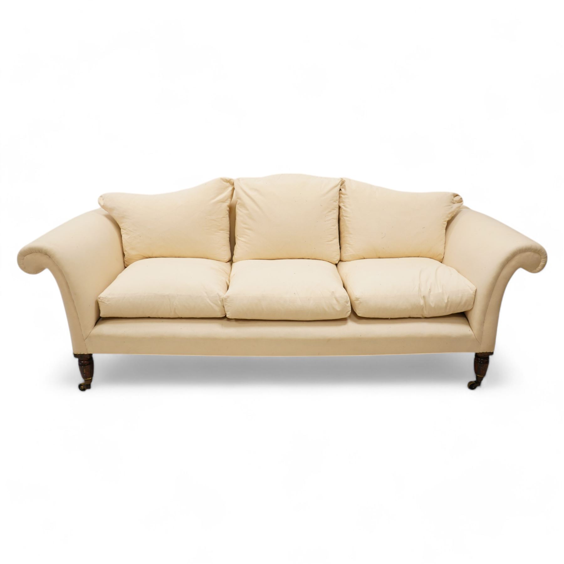 Grande three-seat camelback sofa, upholstered in calico base layer, on turned feet painted to resemble rosewood, fitted with brass cups and castors