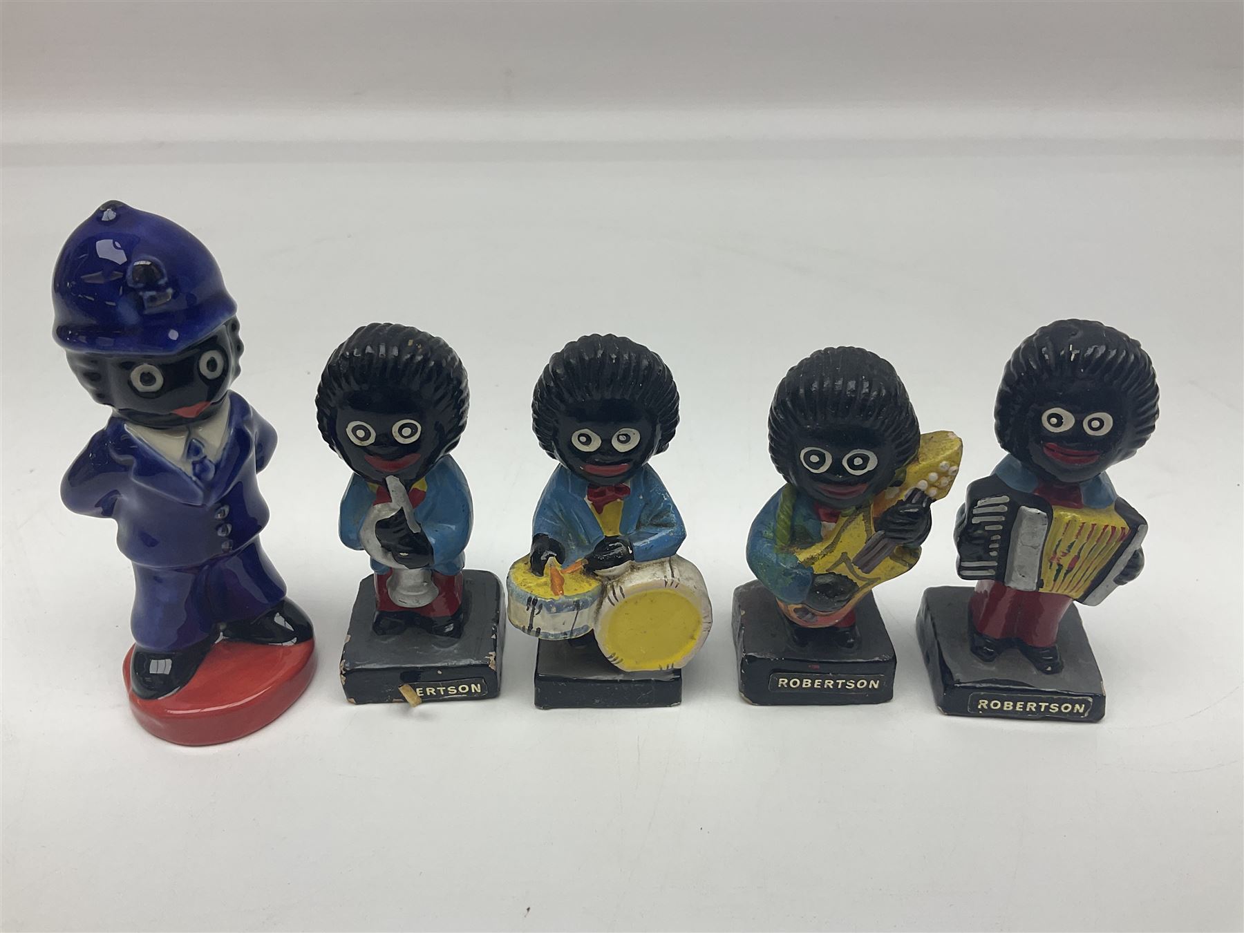 Four Robertson musician golly figures, together with Carlton ware figure etc 