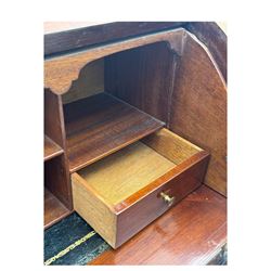 Edwardian inlaid mahogany roll-top desk, cylindrical lid enclosing fitted interior with pigeonholes, drawers and retractable writing surface, over two drawers with brass pull handles, on tapered supports with brass and ceramic castors