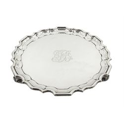 Early 20th century silver waiter, of circular form with pie crust rim, engraved with monogram to centre, upon three foliate feet, hallmarked Thomas Bradbury & Sons Ltd, London 1911, D15.5cm