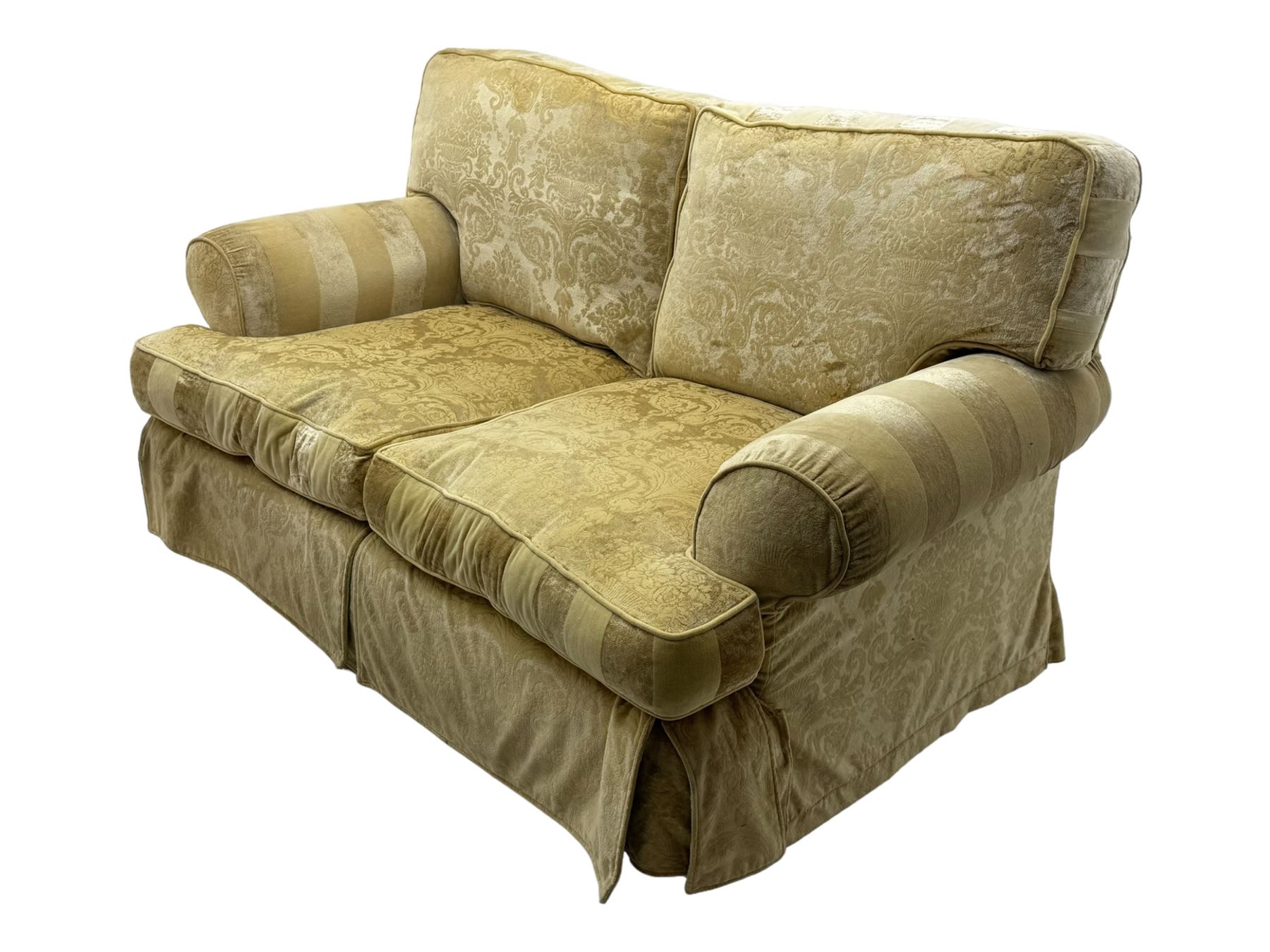 Contemporary two-seat sofa, upholstered in damask fabric with a pale gold floral pattern, rolled arms, loose back and seat cushions, on matching skirted base with concealed castors