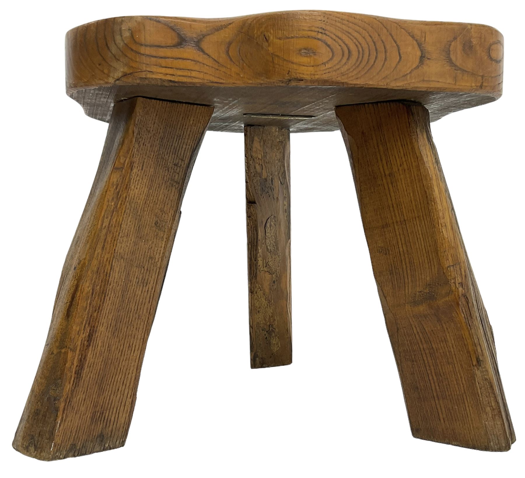 Small rustic elm three-legged stool, with metal plaque to the underneath inscribed 'Wandewood' 