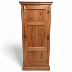 Late 19th century polished pitch pine single wardrobe, moulded cornice over panelled door,...