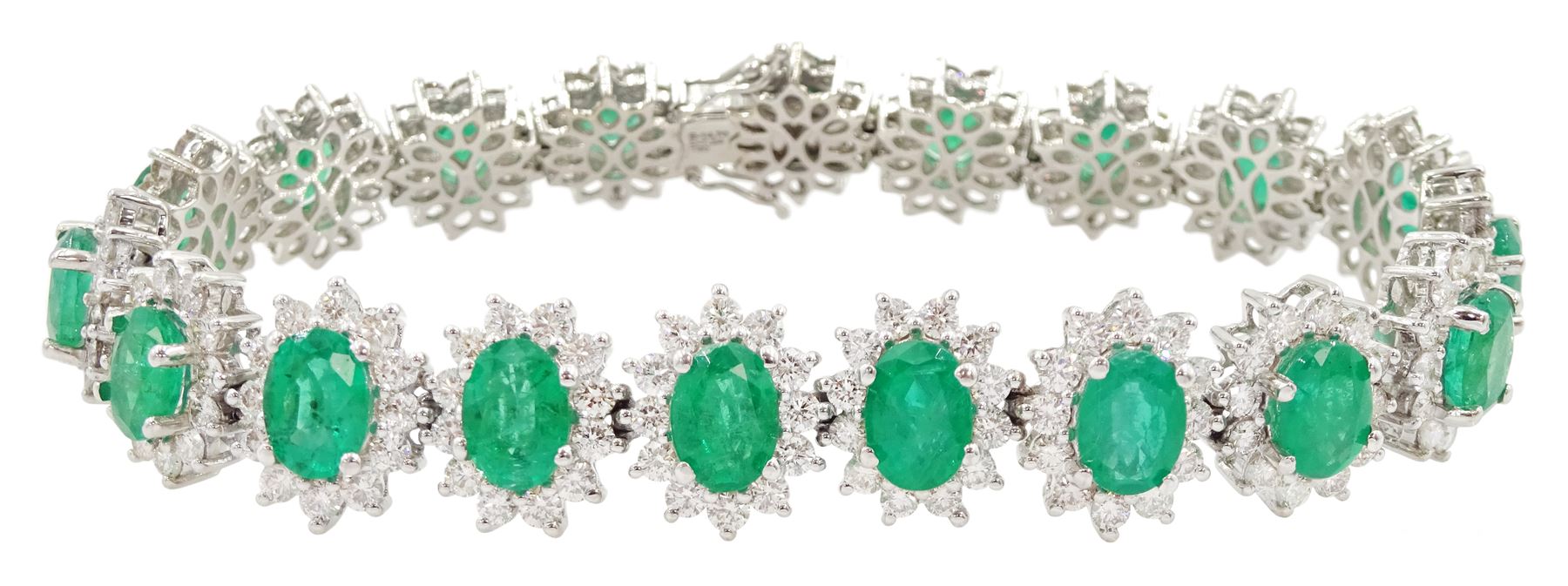 18ct white gold oval emerald and round brilliant cut diamond cluster bracelet, stamped 750, total emerald weight 14.70 carat, total diamond weight 7.24 carat