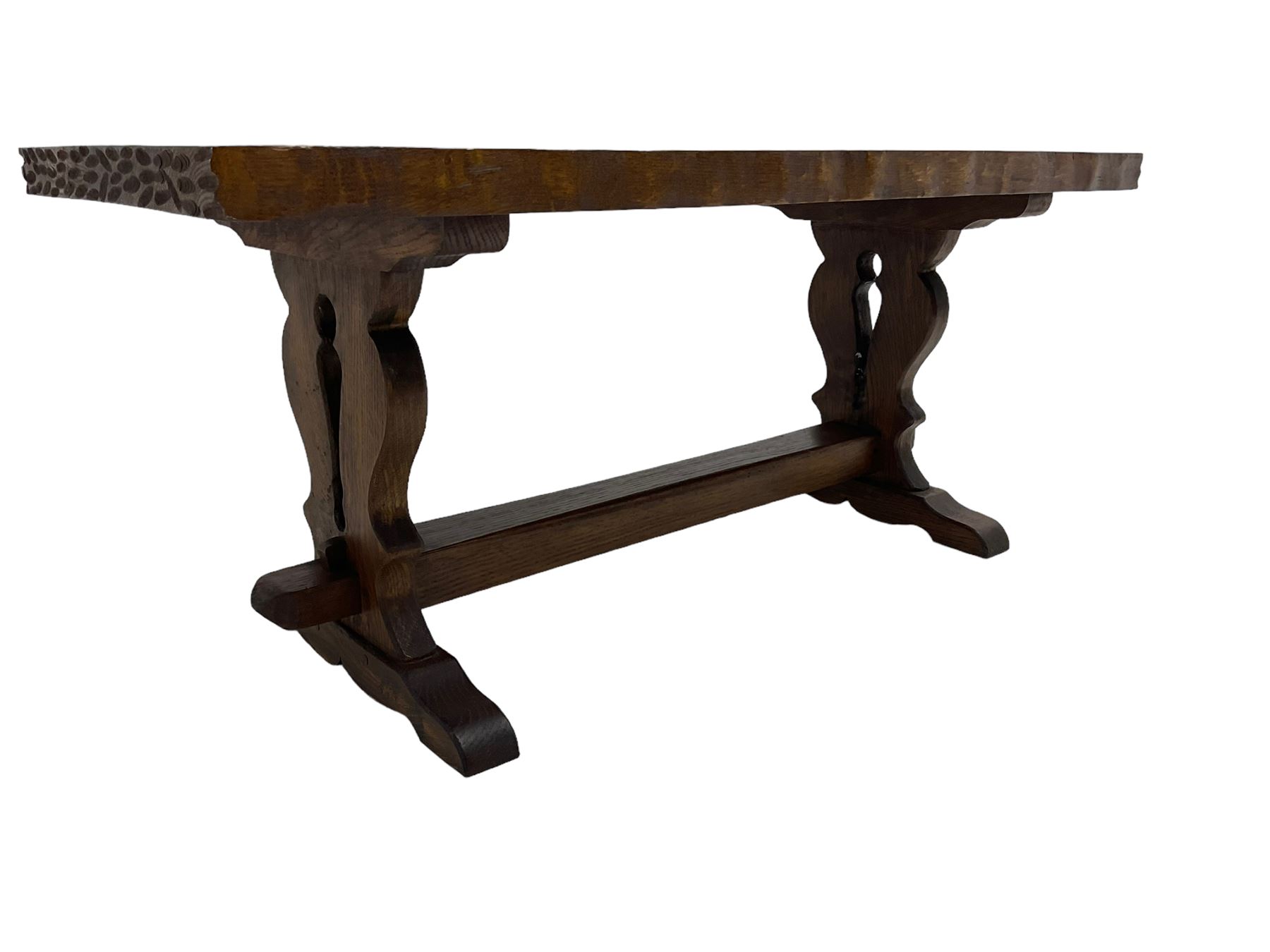 Solid oak coffee table, rectangular waved cut top with tooled ends, on shaped and pierced end supports joined by pegged stretcher 