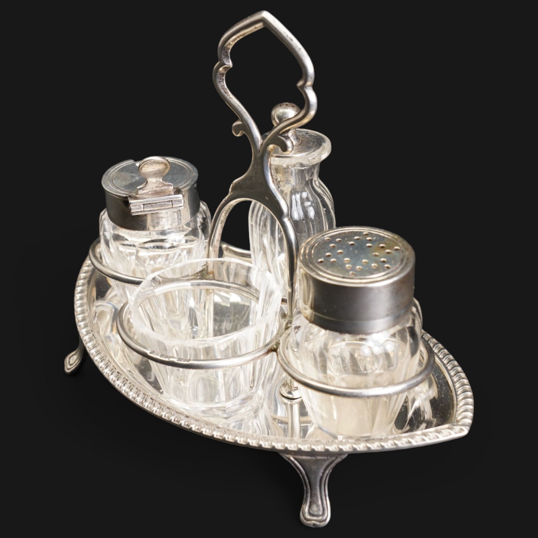 Edwardian small silver navette shape four division cruet fitted with glass and silver mounted bottles London 1902 Maker Hukin & Heath and a pair of mahogany silver banded pepper mills London 1980 Maker Davis Shaw Silverware 