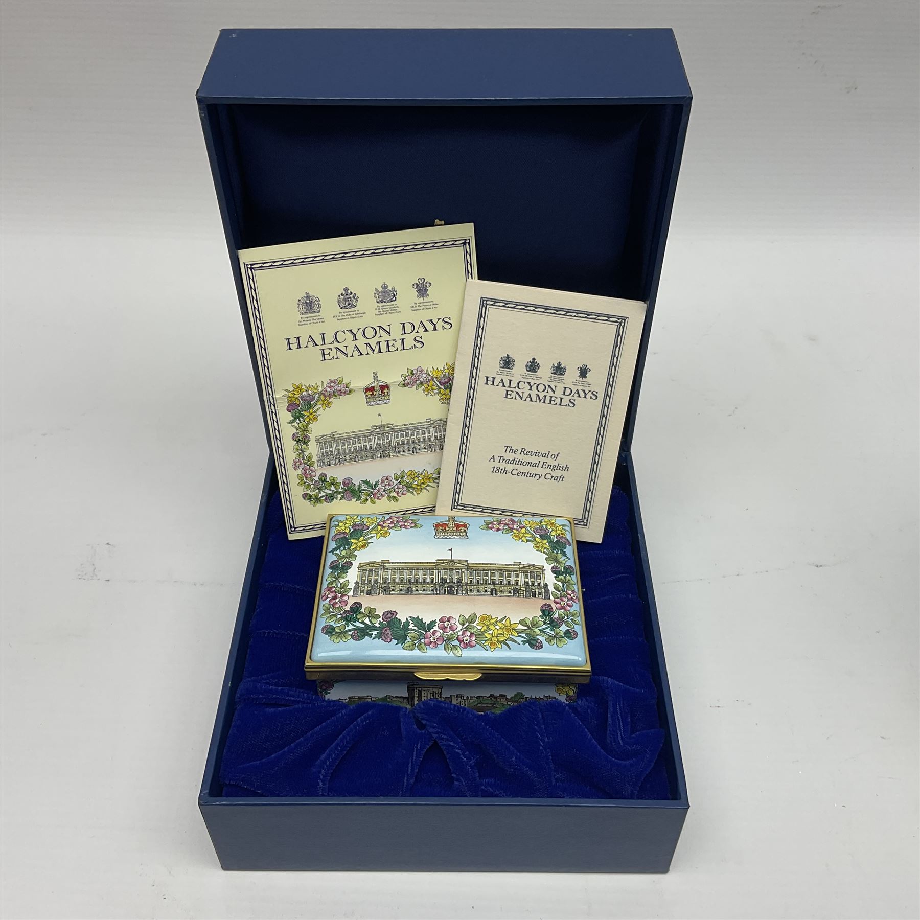 Two Halcyon Days enamel boxes, both of rectangular form, the first depicting Buckingham Palace, 'To Celebrate the Golden Jubilee of Her Majesty Queen Elizabeth', the second depicting the marriage of The Queen and Prince Philip, in celebration of their Diamond Wedding Anniversary, H4cm, W8.5cm, both boxed