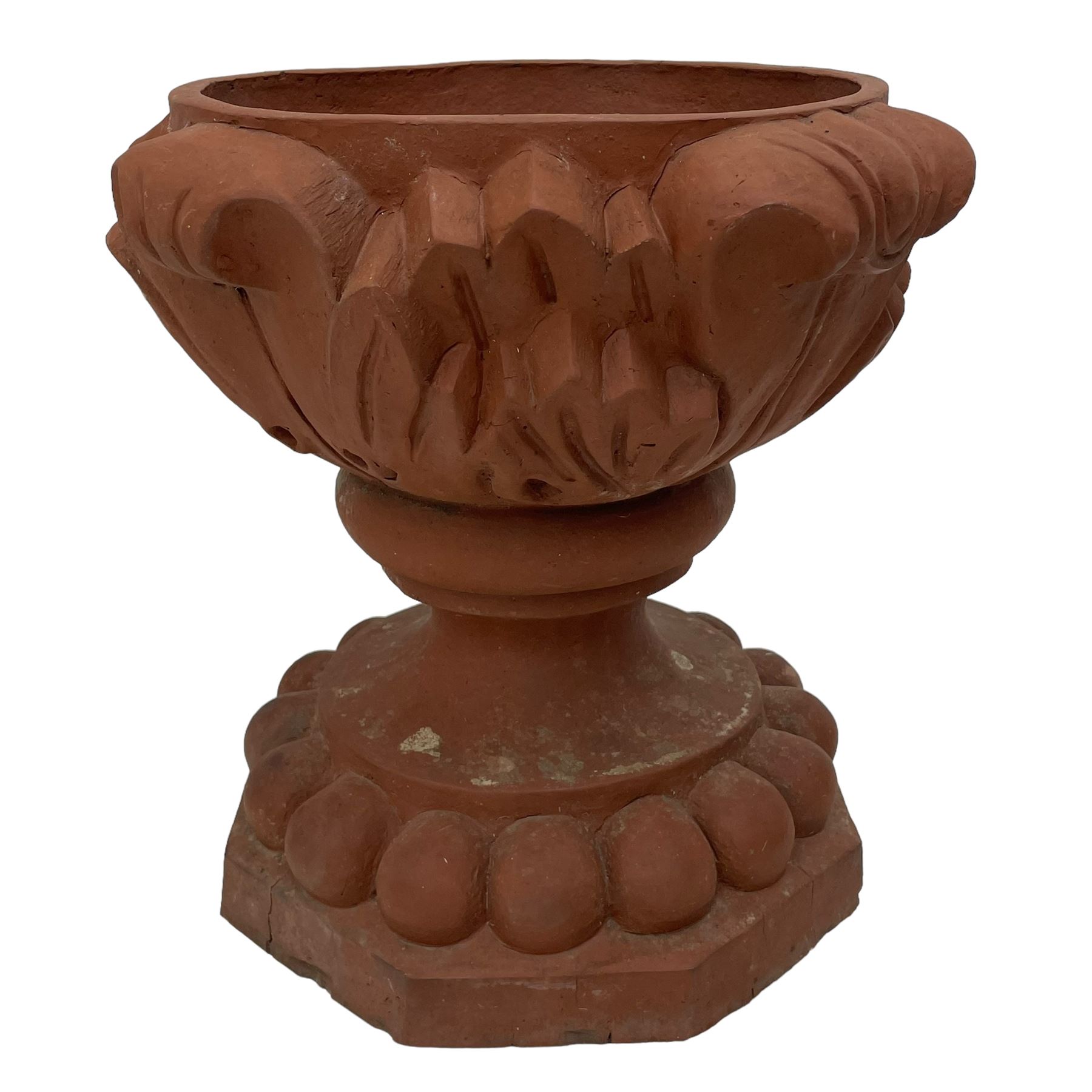 Pair of late 19th to early 20th century red terracotta garden urn planters, the shallow bowls moulded with curled acanthus leaf decoration, on circular foot with globular beaded moulding, octagonal base