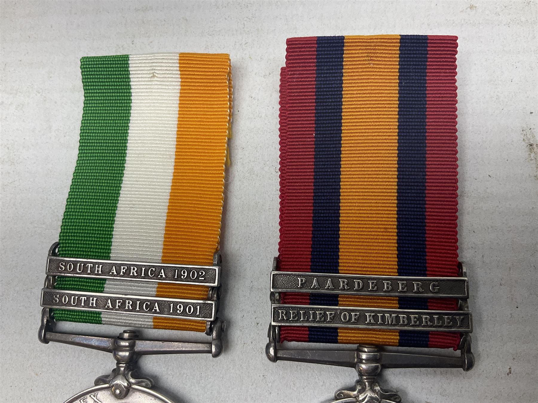 Boer War pair of medals comprising Queens South Africa Medal with two clasps for Paardeberg and Relief of Kimberley and Kings South Africa Medal with two clasps for South Africa 1901 & 1902, awarded to 9752 Dvr. T. Finan A.S.C. with ribbons (2)