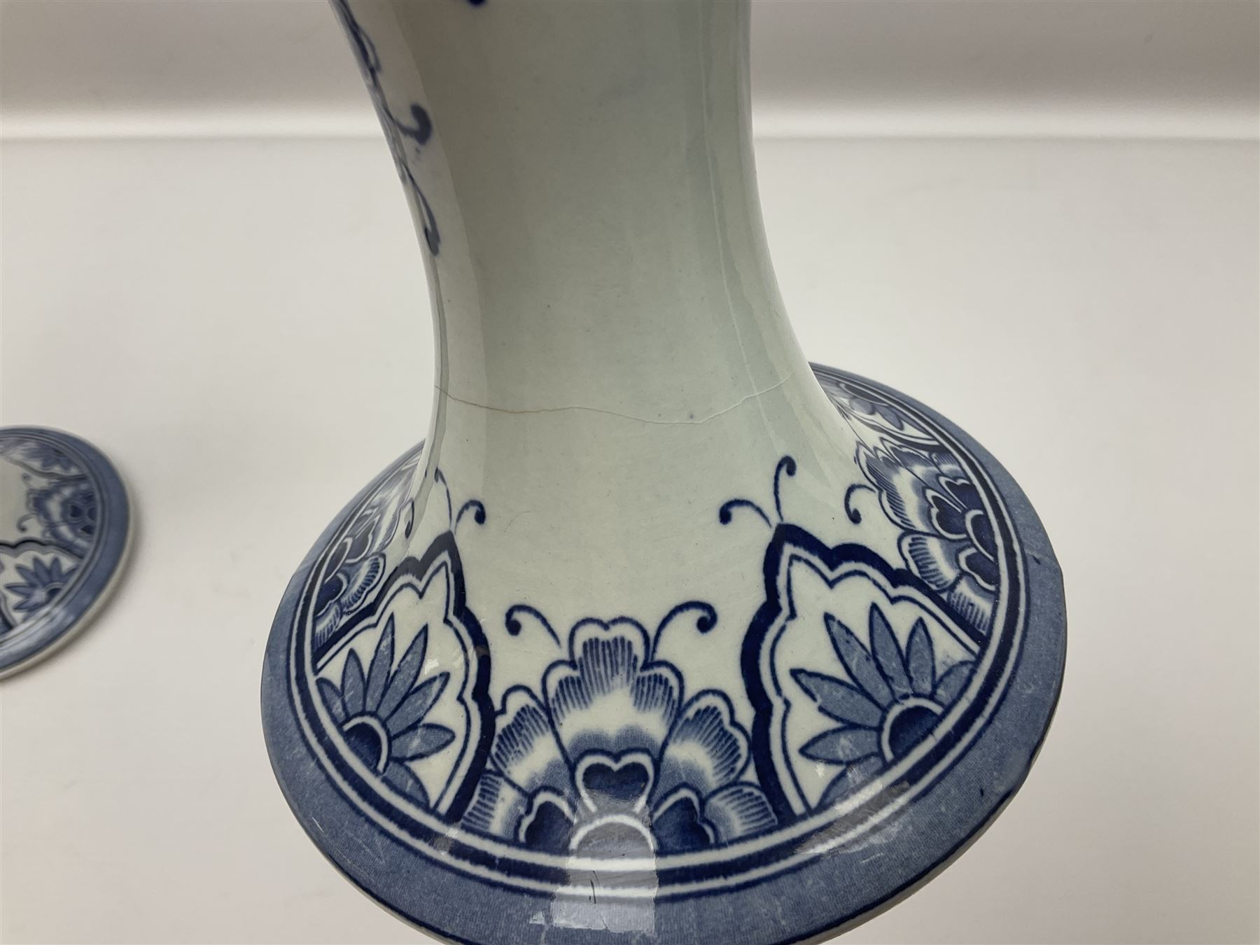 Pair of Delft blue and white vases, of elongated baluster form with shaped fluted rim, one depicting a Dutch sailing scene, the other a Dutch windmill scene, with painted mark beneath, H35.5cm