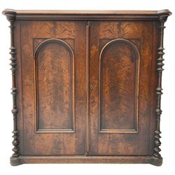 Victorian lacquered mahogany cupboard, fitted with two arch panelled doors enclosing two shelves, flanked by split turned uprights