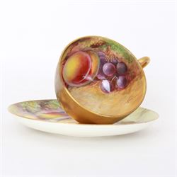 Early 20th century Royal Worcester cup and saucer decorated by Thomas Lockyer, the interior of the cup and the saucer decorated with fruit to a mossy background, with puce printed mark beneath 