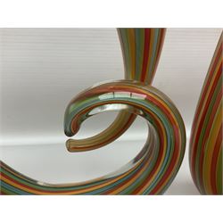 Three art glass sculpture, coiled form with multicolour stranded, upon clear glass plinth, unsigned, largest H27cm