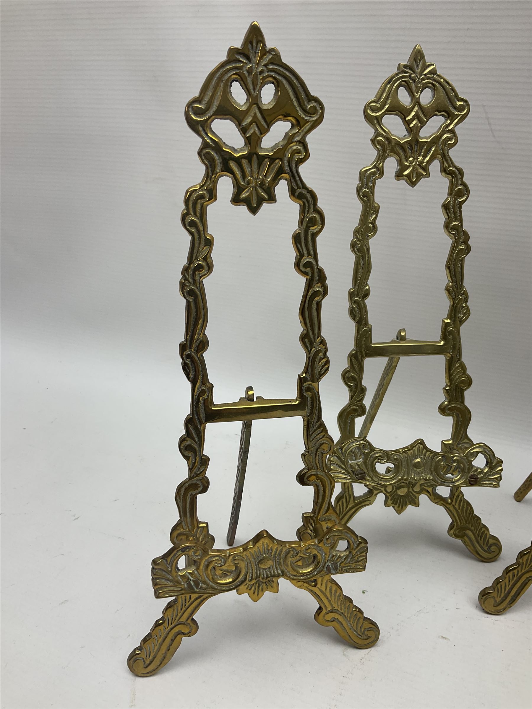 Set of six ornate cast brass easel stands, H30cm