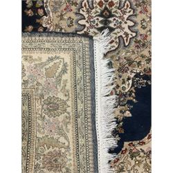 Persian Kirman indigo ground rug, central floral design medallion with matching spandrels, the guarded border decorated with stylised plant motifs 