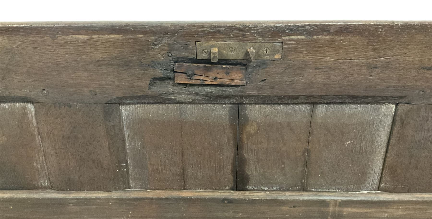 18th century oak coffer or chest, rectangular hinged panelled top with moulded frame enclosing candle box, the frieze carved with foliate S-scrolls over a quadruple panel front decorated with carved lozenges, on stile supports