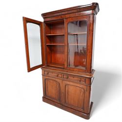 Victorian mahogany bookcase on cupboard, projecting cornice over two glazed doors, the lower section fitted with two drawers and two panelled cupboards, on moulded plinth base 