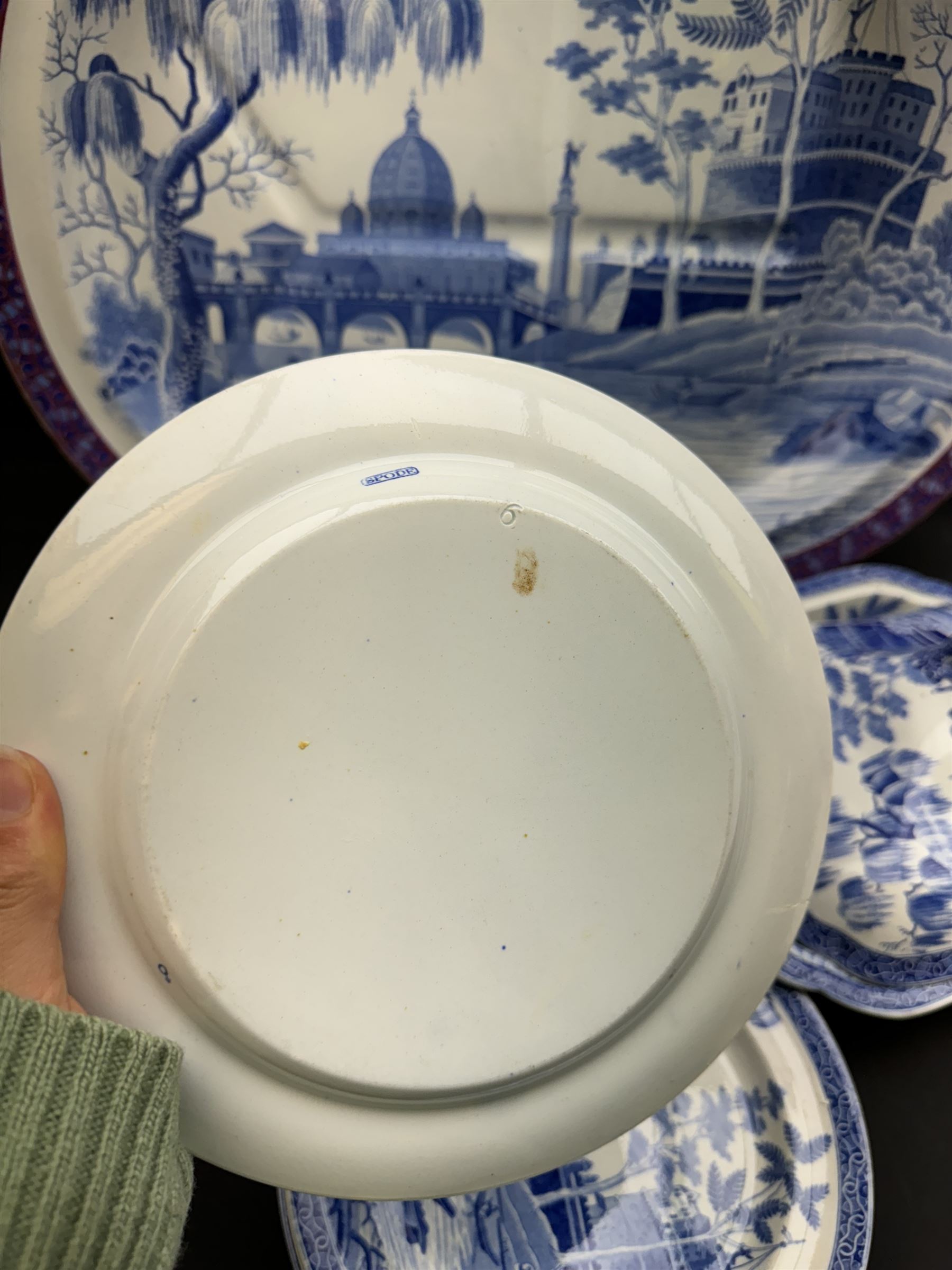 19th century Spode blue and white dinner service for six place settings, decorated in the Tiber pattern, comprising six dinner plates, six dessert plates, meat drainer with red clobbered edge, oval serving dish with twin compartmented interior and matched cover, square serving dish with cover, and two oval platters