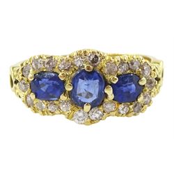 18ct gold three stone oval cut sapphire and diamond cluster ring, stamped 750