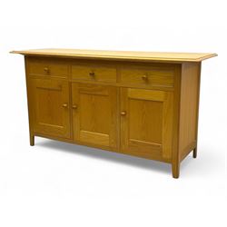 Contemporary light oak sideboard, rectangular top with moulded edge over three drawers and...