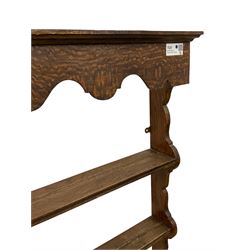 Early 20th century oak wall hanging Delph rack, applied moulded cornice over shaped frieze, three-tiers supports by shaped end supports