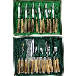 Set of six antler handled knives and forks by Wingen, together with a similar set by Hubertus, both in fitted trays 