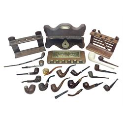 Collection of smoking pipes including Meerschaum pipe, carved as a female head, Briars and clay examples, etc and four pipe racks/stands