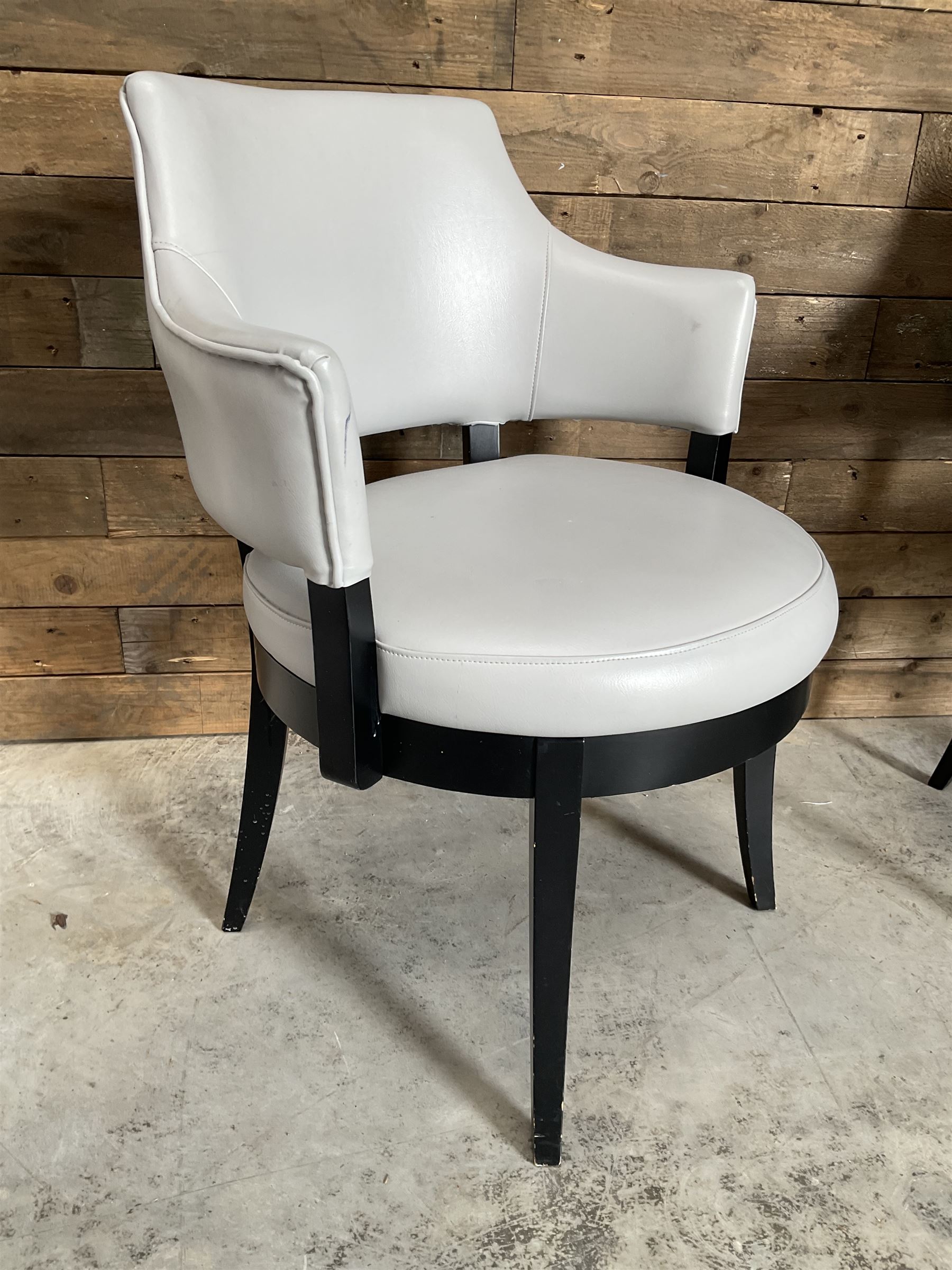 Four ebonised framed tub shaped armchairs, upholstered in grey fabric