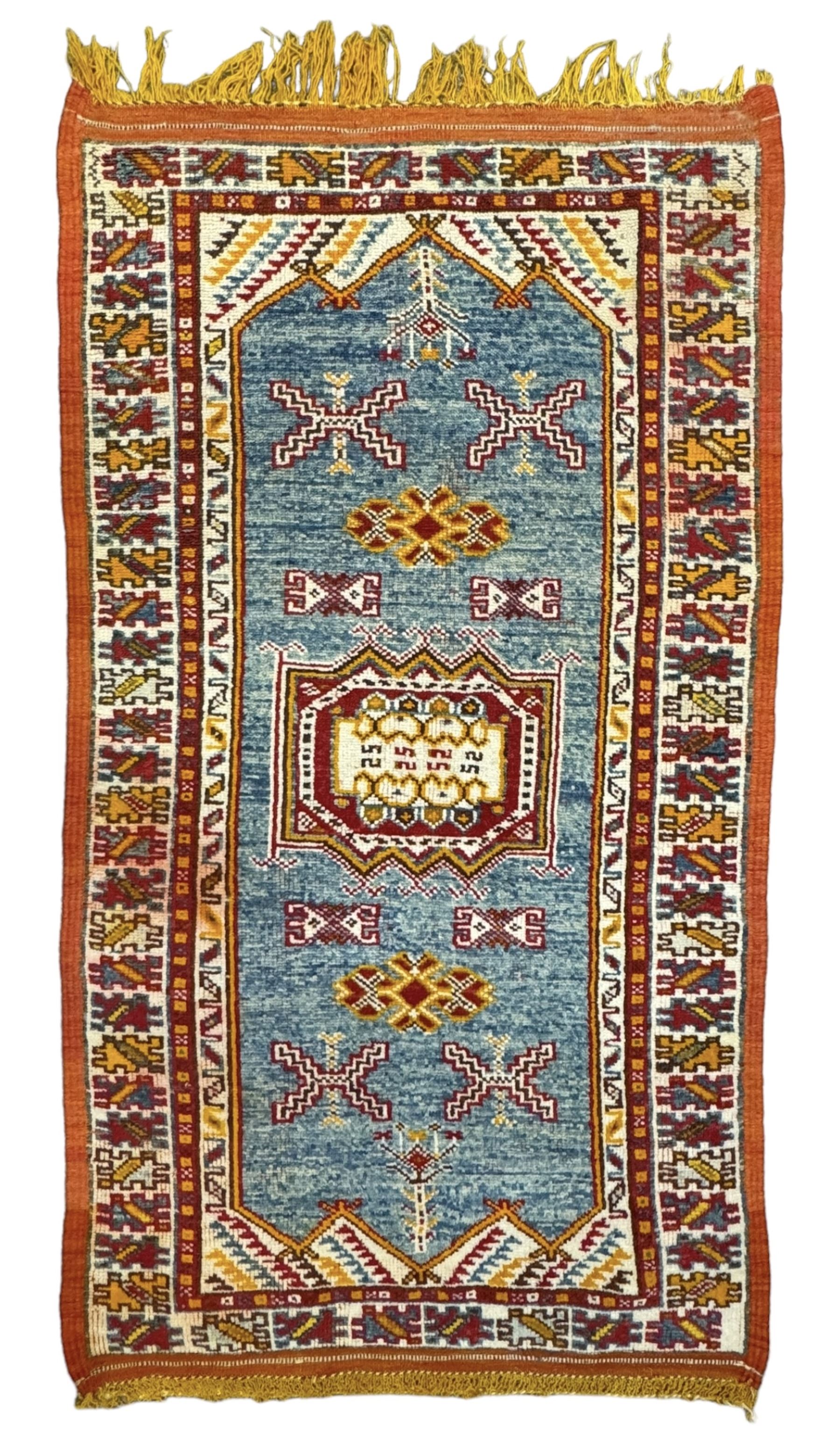 Persian Qashqai crimson ground rug, the field with central indigo and yellow medallion with geometric motifs, flanked by smaller medallions, border with repeating patterns (112cm x 200cm); Turkish Kazak light blue ground rug (109cm x 193cm); red ground runner with three octagonal medallions (69cm x 138cm)