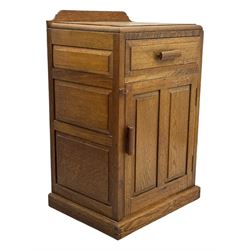 Arts & Crafts period oak bedside cupboard, raised back over moulded top, fitted with single drawer over panelled cupboard, panelled sides, on chamfered plinth base 