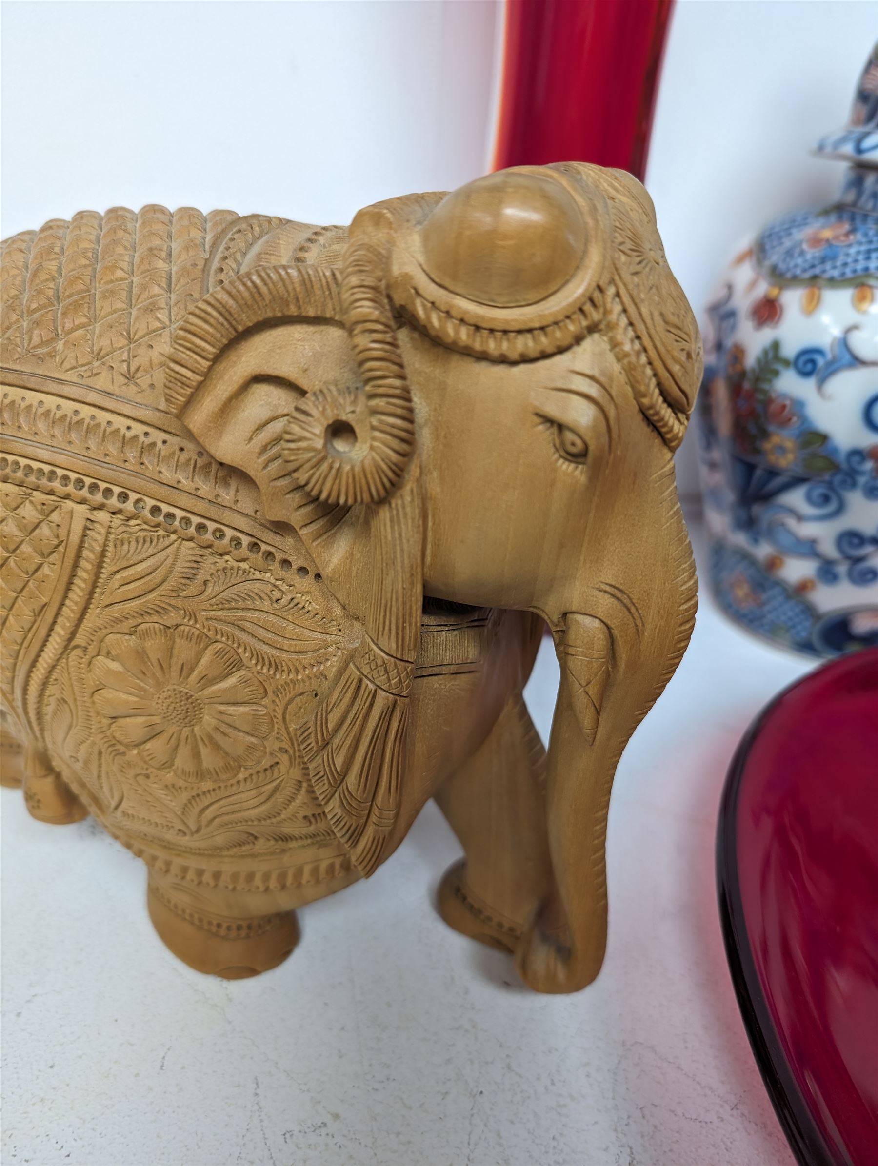 Makkum urn, collection of red art glass including large bowl and a carved wooden elephant, etc