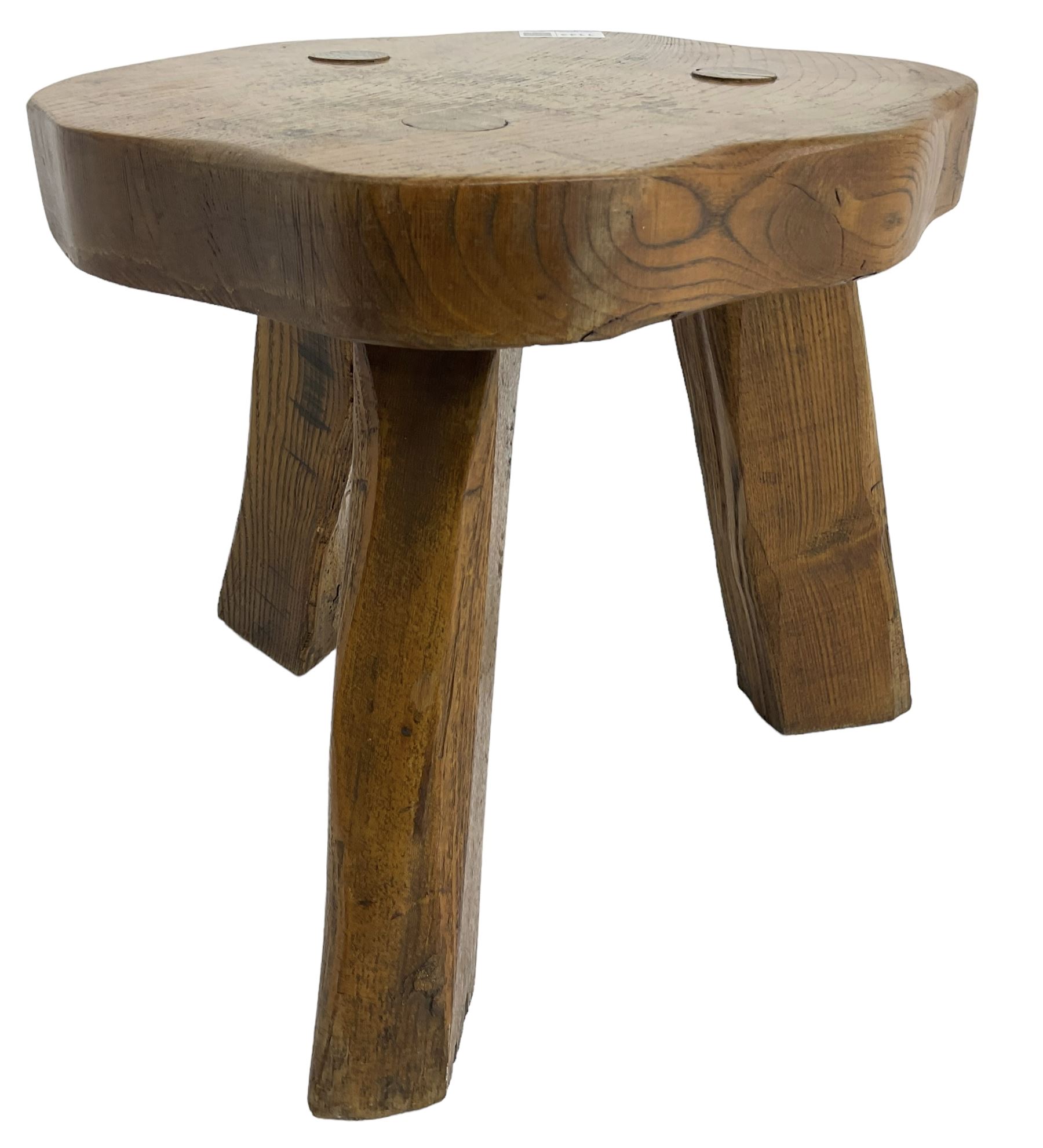 Small rustic elm three-legged stool, with metal plaque to the underneath inscribed 'Wandewood' 