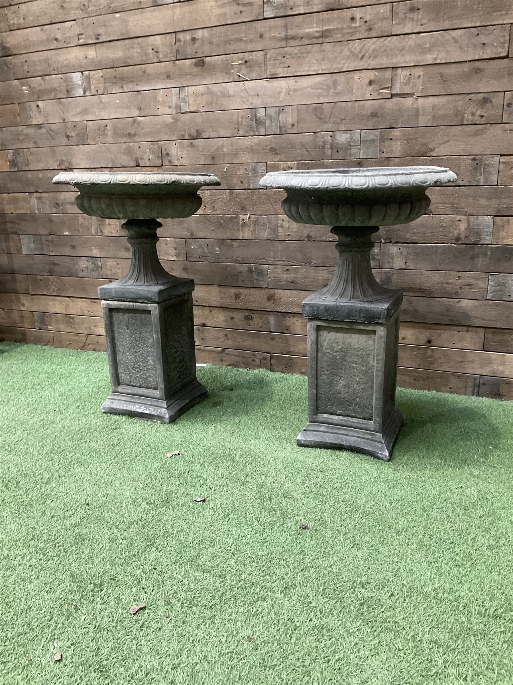 Pair of Victorian design cast stone squat garden urns, egg and dart border, raised on pedestal base and square fielded plinth - THIS LOT IS TO BE COLLECTED BY APPOINTMENT FROM DUGGLEBY STORAGE, GREAT HILL, EASTFIELD, SCARBOROUGH, YO11 3TX