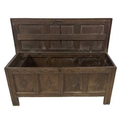 18th century oak coffer or chest, rectangular hinged panelled top with moulded frame enclosing candle box, the frieze carved with foliate S-scrolls over a quadruple panel front decorated with carved lozenges, on stile supports