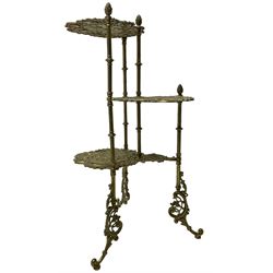 Cast gilt metal three-tier cake stand, each tier decorated with cast foliage scrolls and flower heads with a central bird motif, on turned and fluted supports with splayed C-scroll feet