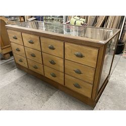 20th century oak and glazed haberdashery shop's display cabinet, fitted with twelve slides, on skirted base - THIS LOT IS TO BE COLLECTED BY APPOINTMENT FROM THE OLD BUFFER DEPOT, MELBOURNE PLACE, SOWERBY, THIRSK, YO7 1QY