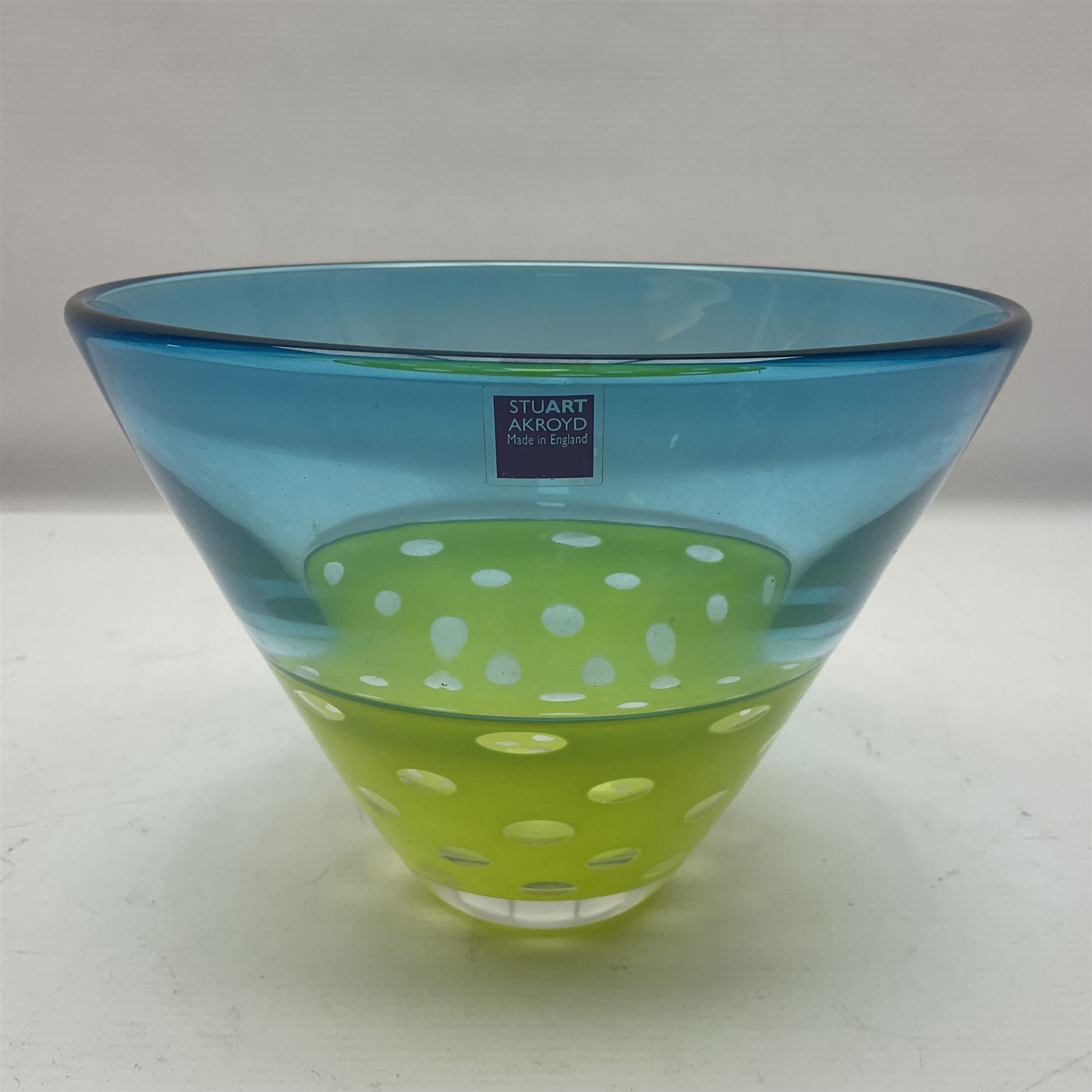 Stuart Akroyd glass vase, blue banded top and lime green opaque lower section with bubble inclusions, with sticker and engraved signature beneath, H15cm