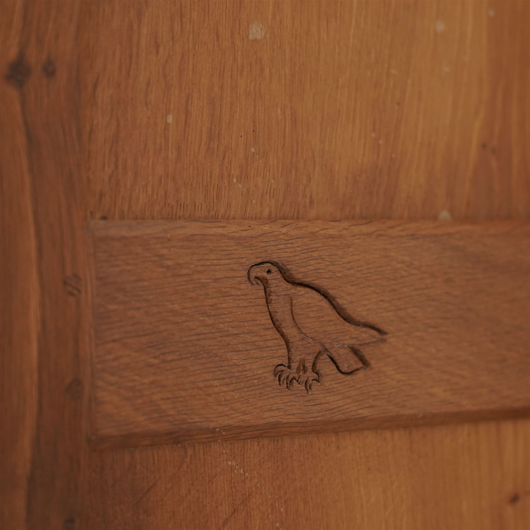 Eagleman - oak bookcase, penny moulded cresting rail over four glazed doors and four panelled doors, fitted with adjustable shelves, on moulded plinth base, panelled sides, carved with eagle signature, by Albert Jeffray, Sessay, Thirsk