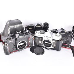 Four Canon SLR camera bodies, to include F-1 serial no. 273243, A-1 serial no. 1818620, EF serial no. 317419, all in black finish, with Canon cases, and an FT serial no. 251226 in black and silver finish